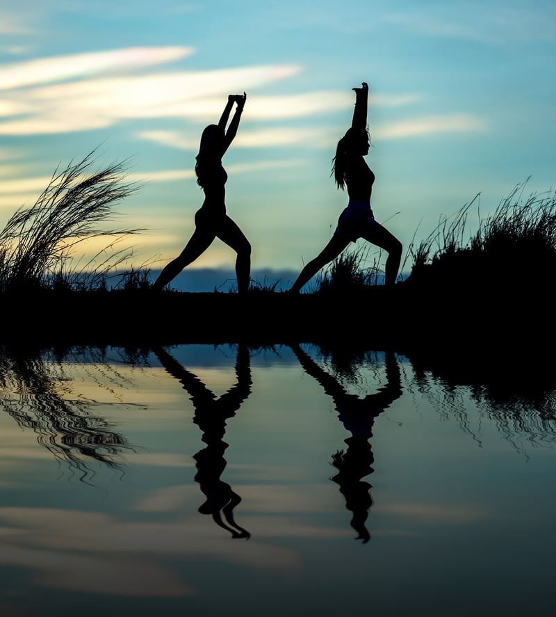 Woman stretching at sunset